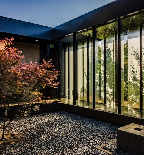 brown and black wooden bench near glass window