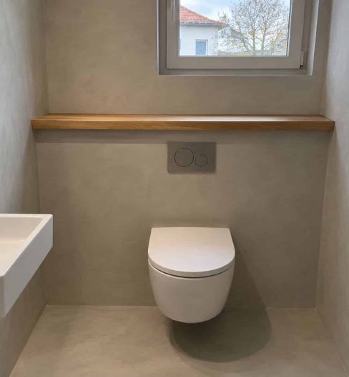 Gäste-WC in hellem Beton-Look, fugenlos